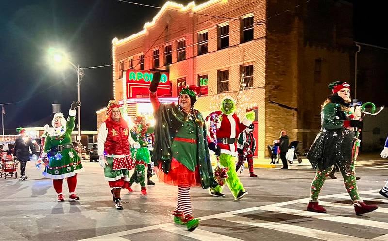People walk in front of the Apollo Theatre during the annual Christmas Parade on Friday, Dec. 6, 2024 in Princeton.