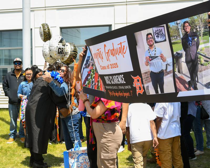 DeKalb High School senior Dice Clarence meets up with family and friends after graduating on Saturday, May 24, 2025, at the Class of 2025 Commencement ceremony held at the Convocation Center in DeKalb..