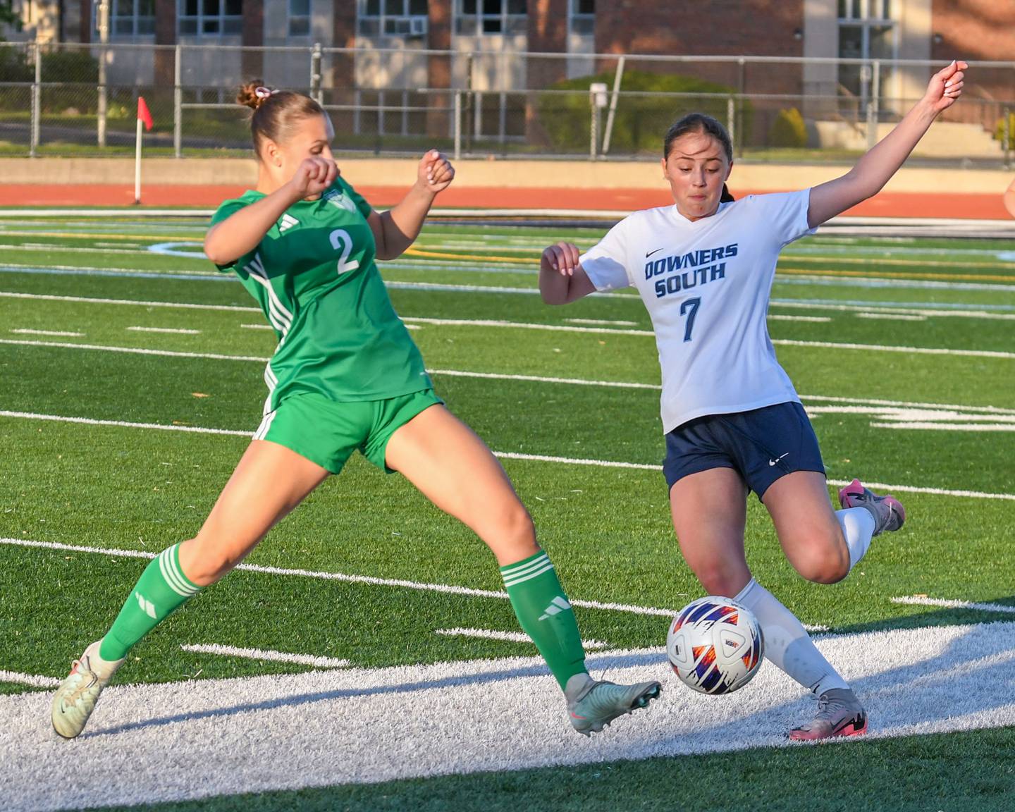 York's Cate Carter (2) and Downers Grove South's Sadie Rhoads (7) battle for the ball on Friday May 23, 2025, during the regional title game held at York High School.