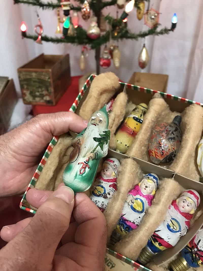 Dave Harms shows off some early, handpainted bulbs in the McHenry County Historical Museum display.