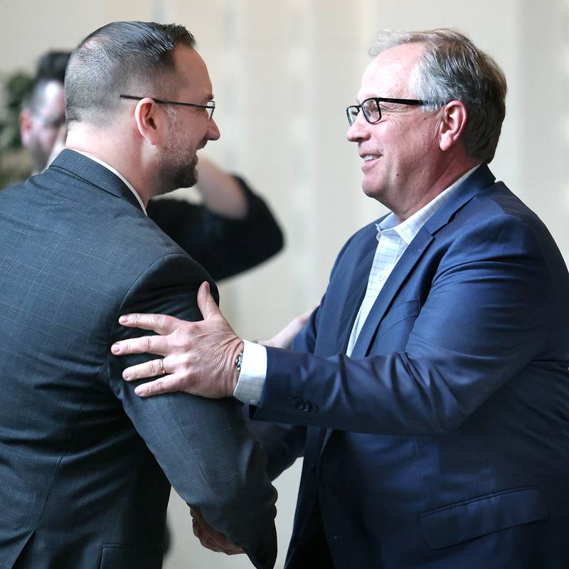 School Tool Box President and CEO Doug Stice (right) is congratulated by Robert Heck, outgoing Sycamore Chamber board president, as he comes up to accept the Outstanding Business of the Year award on behalf of School Tool Box during the 107th Annual Sycamore Chamber of Commerce Meeting Thursday, March 7, 2023, in Memorial Hall at St. Mary's Catholic Church in Sycamore.