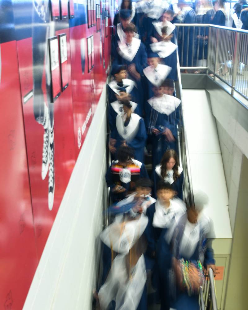 Oswego East graduates make their way inside the Convocation Center in Dekalb on Saturday May 17, 2025, to line up before the start of the commencement ceremony.