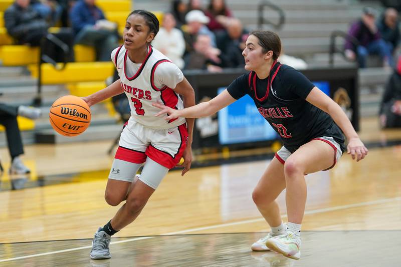 Bolingbrook's Kennedy Williams (2) drives to the hoop against Yorkville's Sydney McCabe (22) during a Class 4A Metea Valley Regional final basketball game at Metea Valley High School in Aurora on Friday, Feb. 21, 2025.