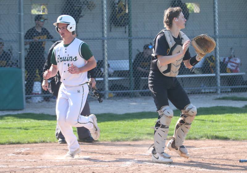 St. Bede's AJ Hermes scores the teams first run as Putnam County catcher Miles Main waits for the late throw to the plate on Thursday, May 8, 2025 at St. Bede Academy.