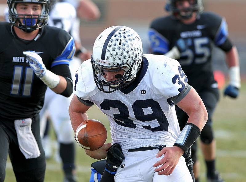Cary Grove's Tyler Pennington (39) fumbles the ball near the end zone against St. Charles North in the second round class 7A state playoff game on Saturday, Nov. 8, 2014 in St. Charles. The ball took a Cary-Grove bounce and Pennington regained control to score a touchdown.