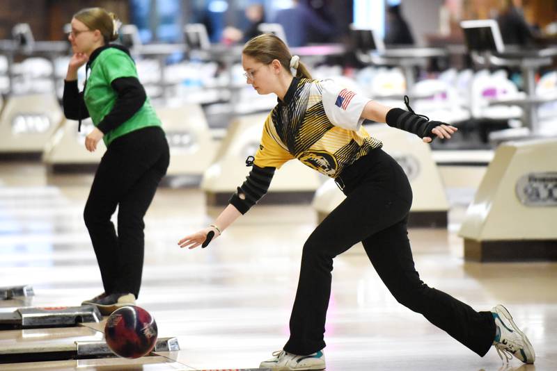 Herscher's Reese Helsel, foreground, bowls as Bishop McNamara's Laura Moore watches her attempt go down the lane during the All-City girls bowling meet at Brookmont Bowling Center in Kankakee Wednesday, Feb. 5, 2025.