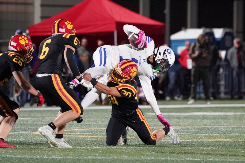 Batavia’s Chase Osborne (20) tackles Geneva’s Talyn Taylor (1) during a football game at Batavia High School on Friday, Oct. 4, 2024.
