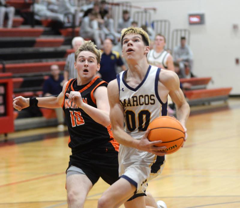 Polo's JT Stephenson (00) drives to the basket as Warren's Alex Niemann gives chase during a Tuesday, Dec. 17, 2024 game at the 63rd Annual Forreston Holiday Tournament.