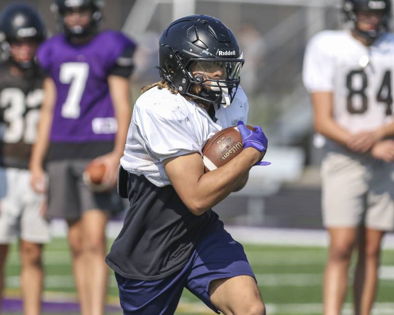 Kevin Jay runs with the ball at Downers Grove North High School football practice, Thursday, Aug 14, 2025  in Downers Grove.