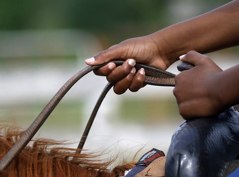 Richard Taylor-Terry, 11, holds the reins as he takes a riding lesson on retired Medieval Times horse, Hunter, Friday July, 8, 2022, at the R Double J Ranch, 2800 Derby Lane, in McHenry. The R Double J Ranch recently got the contract to operate this equine facility from McHenry with the goal of making it more of a community-centric center and make learning about horses and riding open to all.