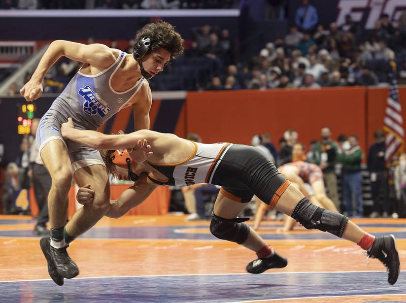 Sandwich’s Cooper Corder (at right) explodes toward Princeton’s Ace Christiansen in the 138-pound 1A third-place match at the IHSA State Finals at the State Farm Center in Champaign.