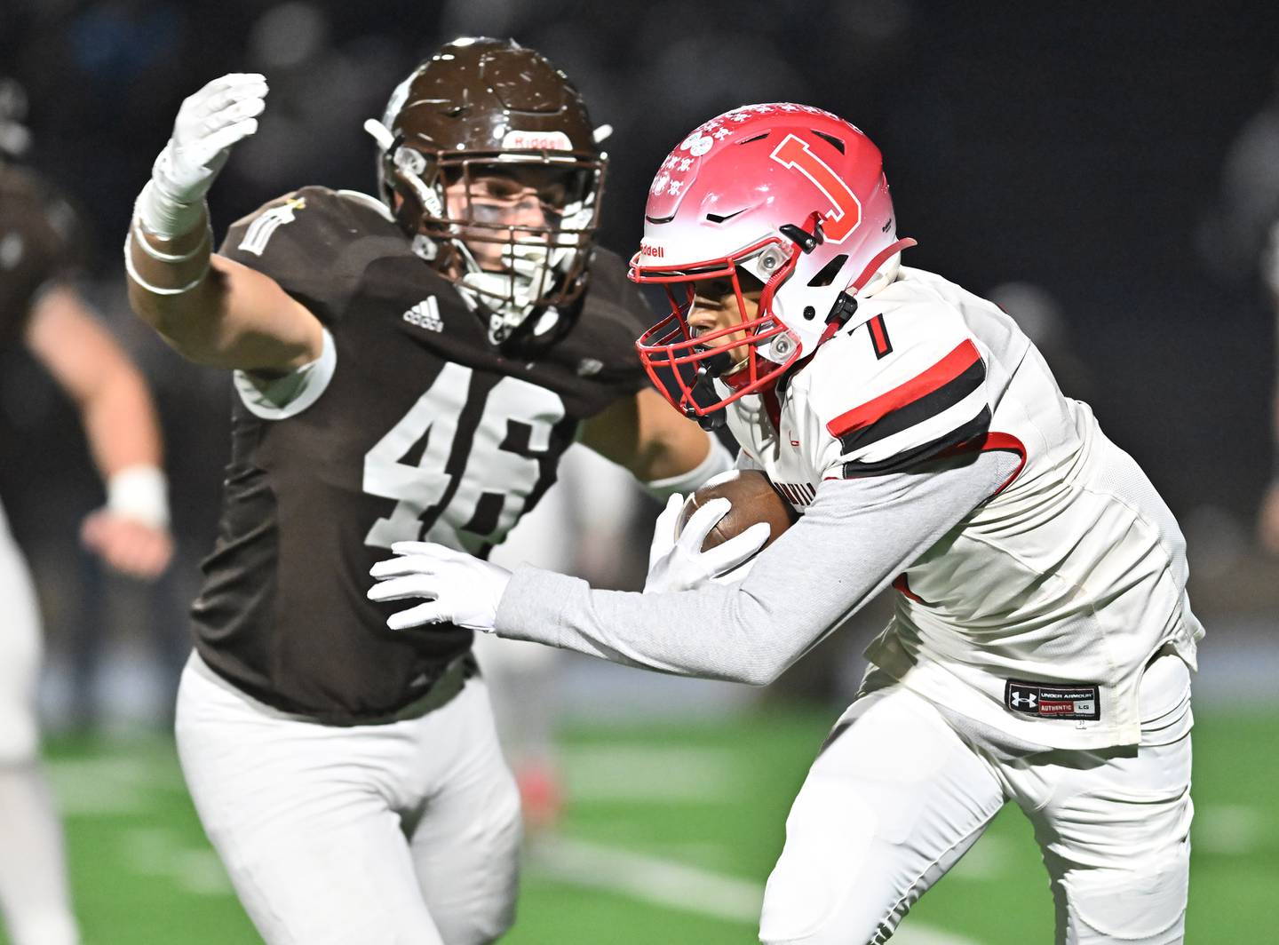 Jacksonville's Charles Kholian (7) tries to elude Joliet Catholic's Derrick Pomatto (46) during the IHSA Class 5A first round playoff game on Saturday, Nov 02, 2024 at Joliet. (Dean Reid for Shaw Local News)