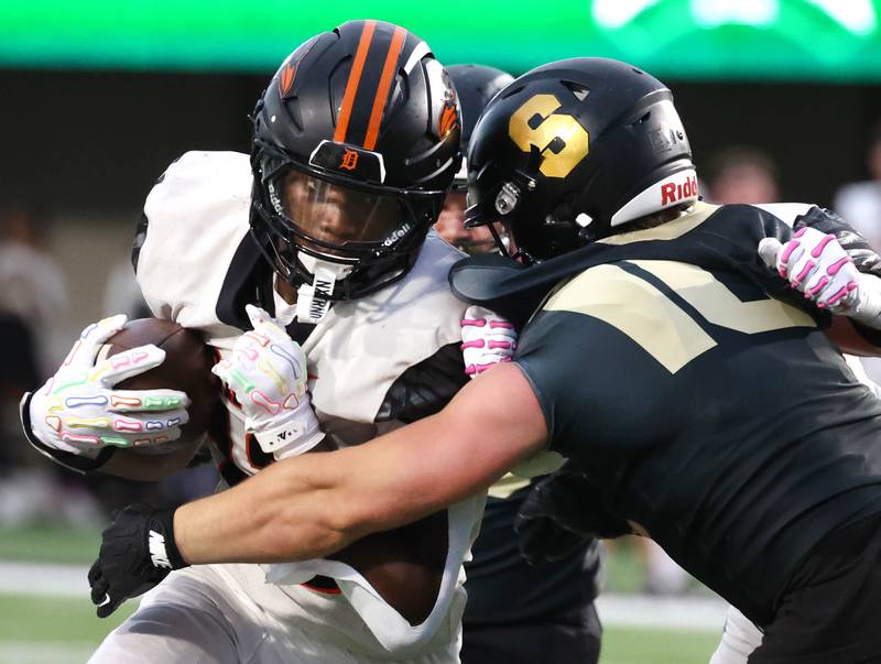 DeKalb's Davon Grant is tackled by Sycamore's Dawson Gurley near the goalline Friday, Aug. 29, 2025, during the FNBO Challenge in Huskie Stadium at Northern Illinois University.
