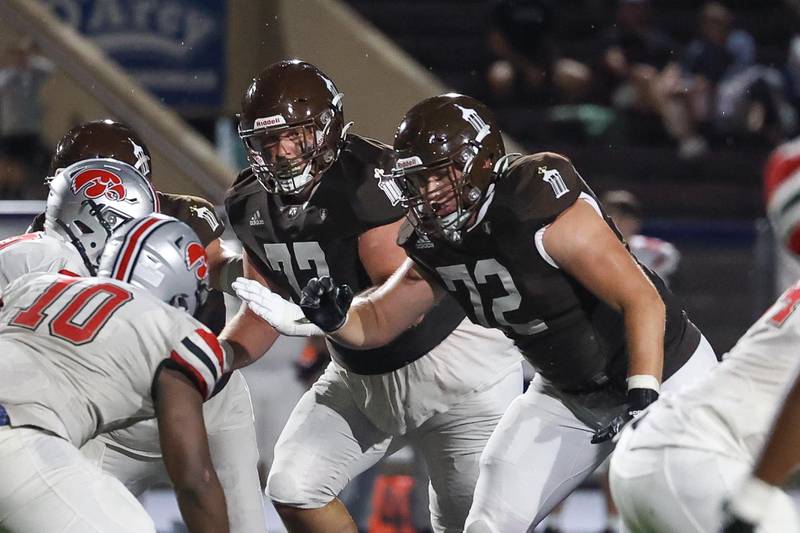 Joliet Catholic’s Cam Juricich, left, and Jake Jokovich hold the line against Iowa City on Friday, August 30, 2024 in Joliet.