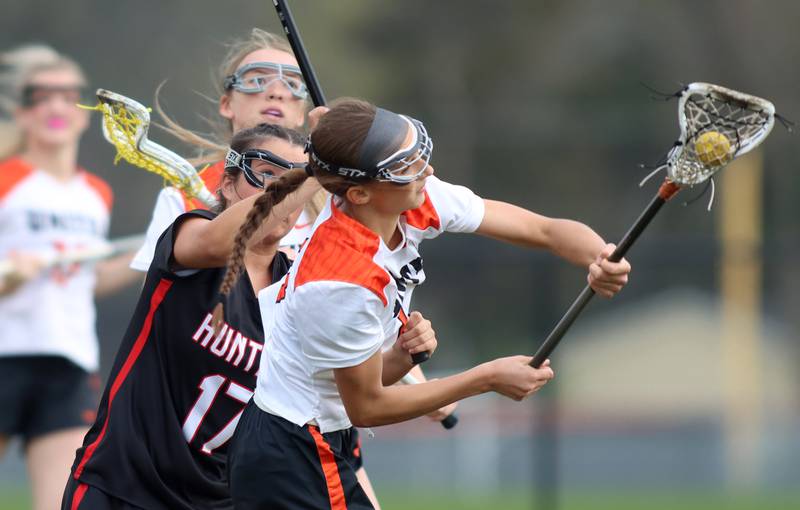 Crystal Lake co-op’s Addie Bechler moves the ball against Huntley in varsity girls lacrosse on Friday, April 18, 2025, at Metcalf Field on the campus of Crystal Lake Central High School in Crystal Lake.