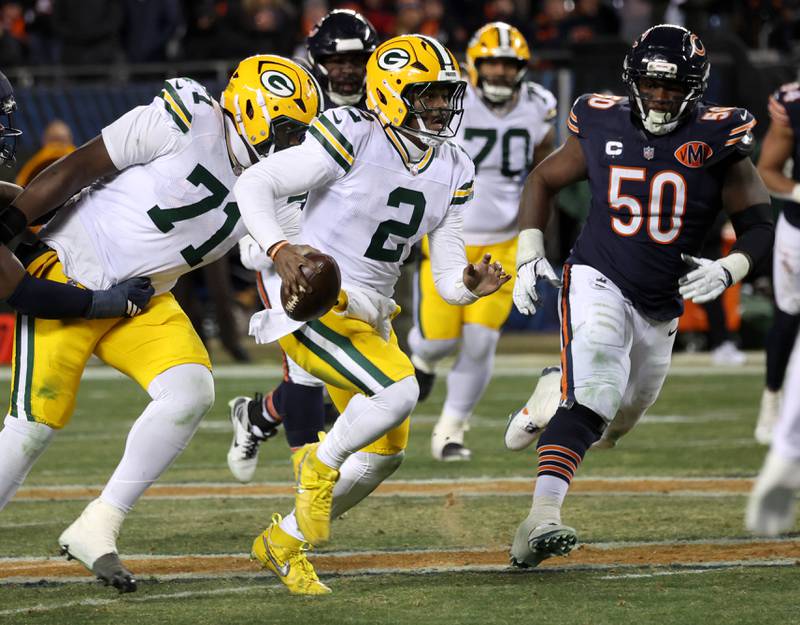 Green Bay Packers quarterback Malik Willis scrambles away from the Chicago Bears pass rush Saturday, December 20, 2025, during their game at Soldier Field in Chicago.