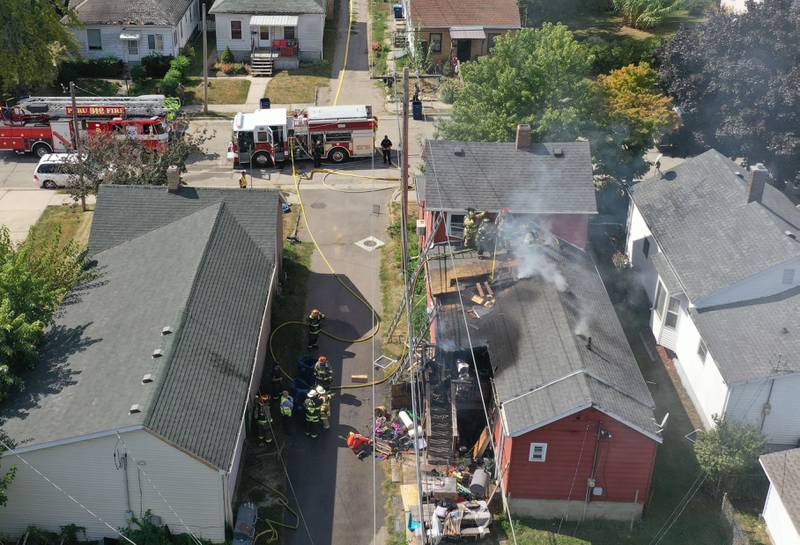 La Salle and Peru firefighters work the scene of a structure fire as smoke emits from the attic from a home in the 300 block of Crosat Street on Thursday, Sept. 19, 2024 in La Salle. The fire happened shortly after 12:30p.m.