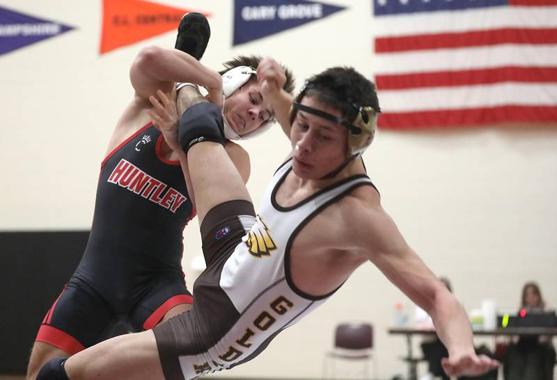 Huntley’s Matt Keaty takes down Jacobs’ Daniel Delbosque during the 157—pound match of a Fox Valley Conference wrestling meet on Thursday, Dec. 11, 2025, at Huntley High School.