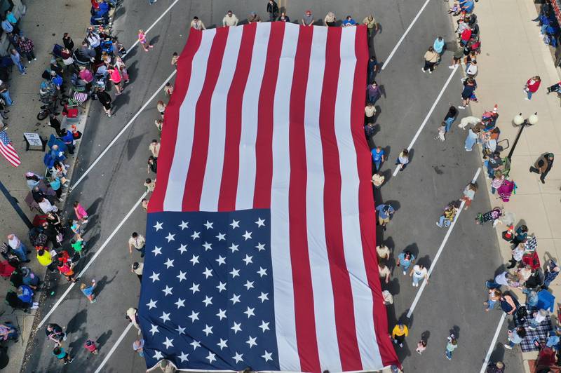 An aerial view of the giant American flag as it is carried down South Main Street during the 54th annual Homestead Festival parade on Saturday, Sept. 6, 2025 in Princeton.