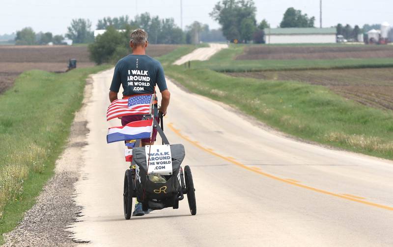 Tom Boerman, from the Netherlands, walks north on Ault Road near Kirkland Tuesday, May 24, 2022, hoping to make it to Rockford by the end of the day. Boerman, who stopped for the night at a home in DeKalb, is on a quest to walk around the world while raising money for schools in Nepal that were hit hard by the 2015 earthquake in the region.