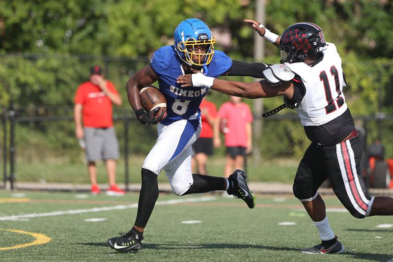 Simeon’s Malik Elzy stiff arms a defender against Bolingbrook. Saturday, Sept. 3, 2022, in Chicago.