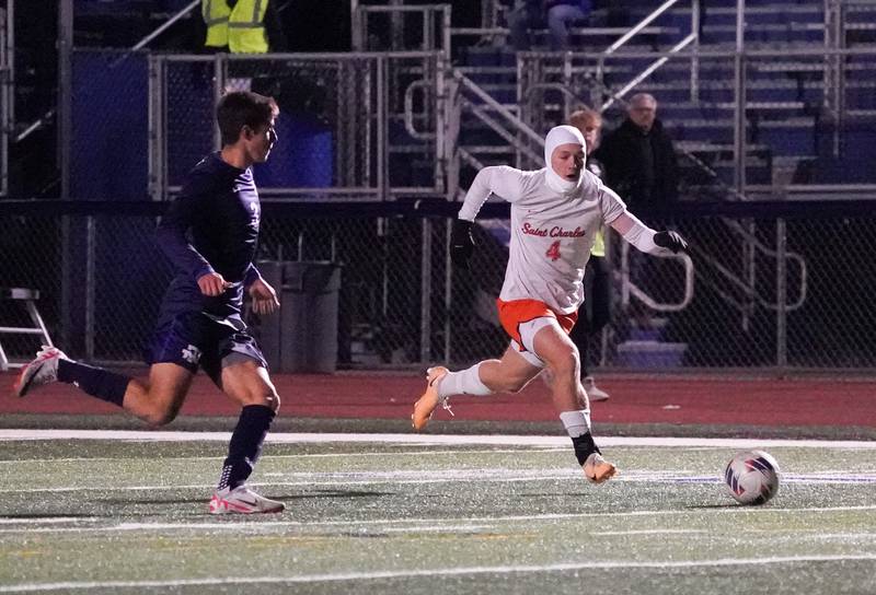 St. Charles East's Griffin Counts (4) plays the ball on a fast break against New Trier's Liam Myers (3) during the class 3A St. Charles North Boys Soccer Supersectional match at St. Charles North High School on Wednesday, Nov. 1, 2023.