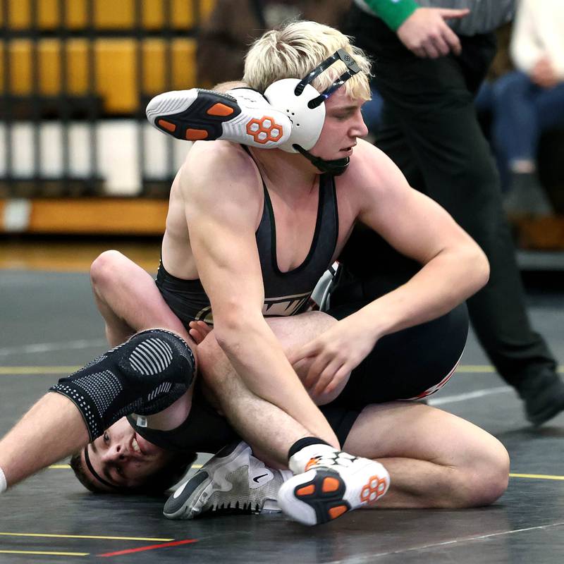 Sycamore’s Cooper Bode looks to get control of Kaneland’s Apollo Gochis during their 175 pound match Thursday, Jan. 9, 2025, at Sycamore High School.