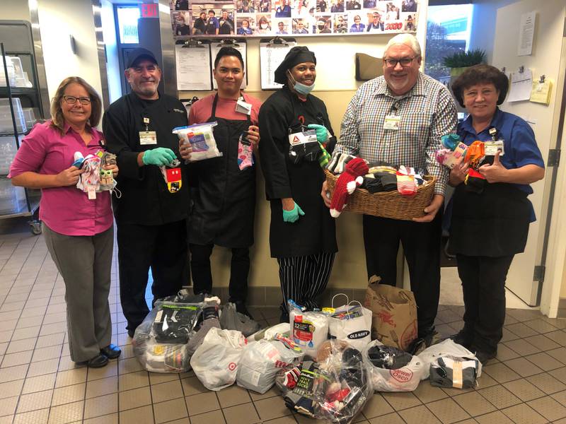 During the month of October 2022, Silver Cross Hospital in New Lenox collected more than 700 pairs of socks as part of its Socktober campaign. Silver Cross will donate the socks to The Salvation Army in Joliet. Pictured from left are Silver Cross nutrition services team members Wanda Gifford, Marco Larios, Neil Estrada, Romain Dockery, Brad Davis and Kay Johnke.