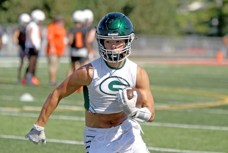 Glenbard West’s Joey Pope runs with the ball during a 7 on 7 football tournament at Batavia High School on Thursday, July 14, 2022.