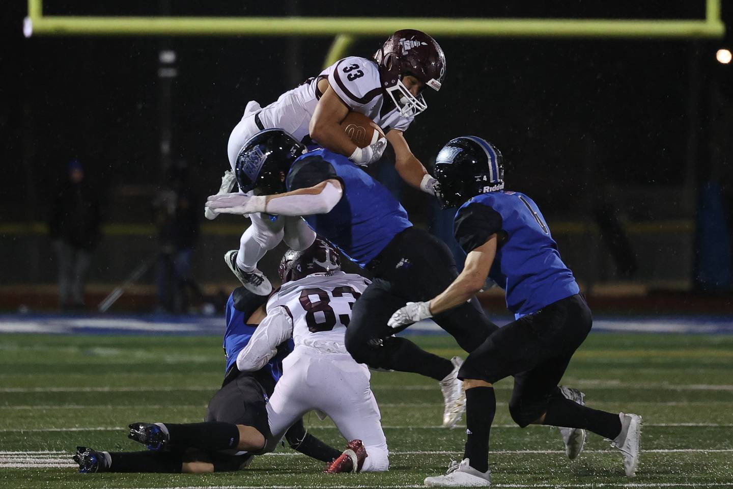 Lockport’s Giovani Zaragoza takes a hit hurdling several players on a run against Lincoln-Way East Friday night.
