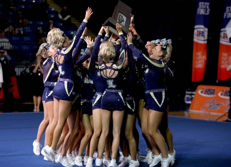 Members of the Lemont cheerleading team celebrate their first-place finish in the medium team division of the IHSA State Finals on Saturday, Feb. 8, 2025 at Grossinger Motors Arena in Bloomington.