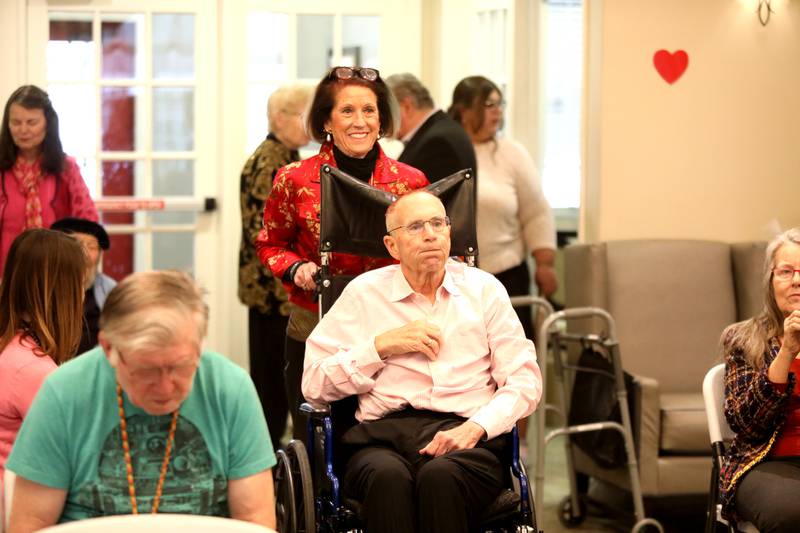 Sherri and William Bowne, who have have been married for 53 years, go down the aisle before renewing their wedding vows on Friday, Feb. 14, 2025 at Churchill Place, an Anthem Memory Care community in Glen Ellyn.