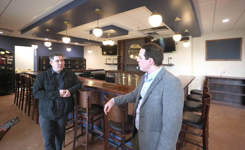 The Grove restaurant and bar owners Jason Engstrom (left) and Sam Patterson talk Thursday, March 23, 2023, at the new eatery in DeKalb. They plan to open their doors upon completion within the next few weeks.