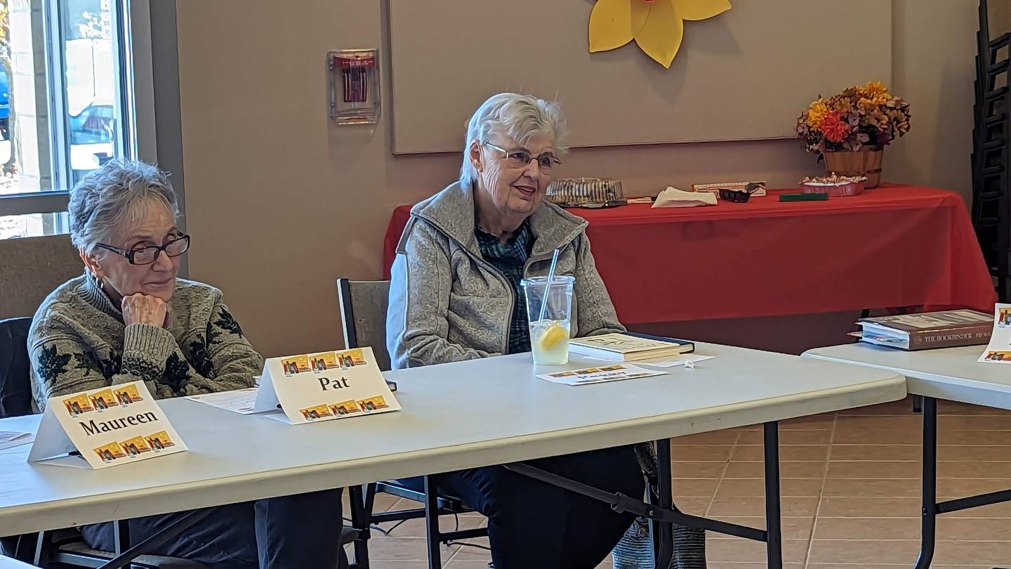 The Joliet Public Library Book Group celebrated its 25th anniversary on Tuesday with bakery from the Book and Bean Café at the Black Road branch, where book group meets. Pictured, from left, are members Pat Butterbach of Joliet and Peggy Ashby of Plainfield.