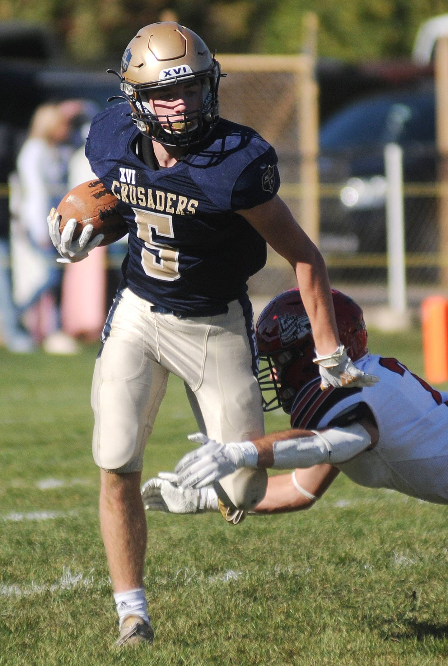 Marquette's Tom Durdan (5) avoids a tackle by Fulton's Brock Mason at Gould Stadium on Saturday, Nov. 6, 2021.