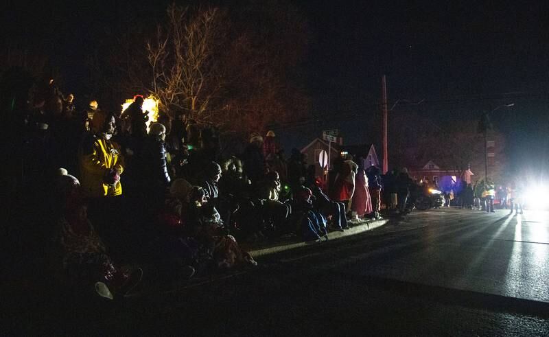 Parade spectators look to the start of the Holiday Homecoming Electric Christmas Parade before it begins in St. Charles on Saturday, Nov. 30, 2024.