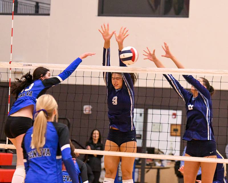 Nazareth Academy’s Grace Gravante, right, blocks the ball while teammate Jane Manecke, center, helps block while Geneva's Zoriana Malone (13) spikes the ball during the sectional title game on Thursday Nov. 6, 2025, held at Timothy Christian High School.