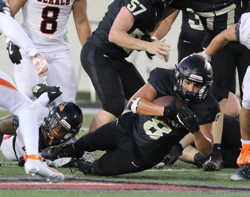 Sycamore's Diego Garcia stretches for extra yardage during the First National Challenge game Friday, Aug. 25, 2023, in Huskie Stadium at Northern Illinois University in DeKalb.