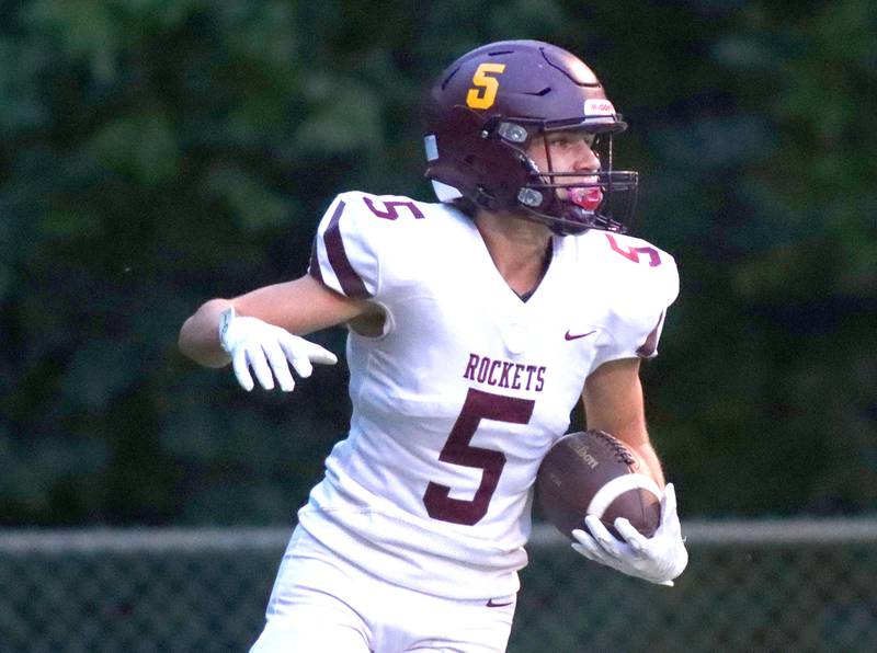 Richmond-Burton’s Gavin Saranzak lands in the end zone with a touchdown against Marian Central in varsity football at George Harding Field on the campus of Marian Central High School in Woodstock on Friday, August 29, 2025.