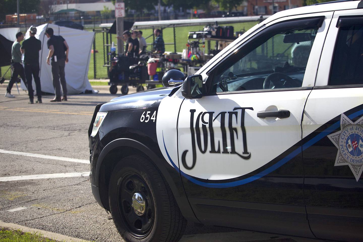 A Joliet Police Department squad vehicle near the filming of HBO TV pilot "Amercian Blue" by the Joliet Slammers baseball stadium on Tuesday, April 28, 2026, on East Van Buren Street in Joliet.