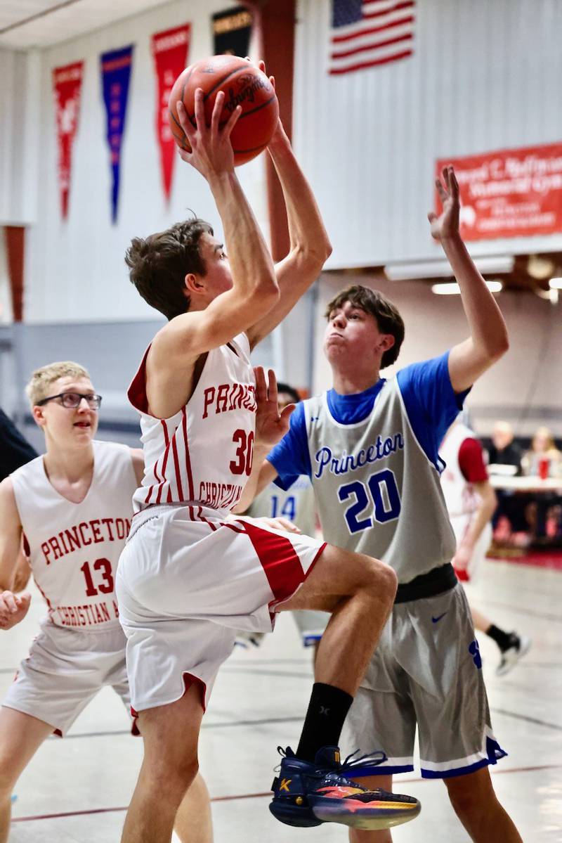 PCA's Matthew Gibson shoots a layup over Princeton's Brody Ross in Thursday's JV game at Howard Hoffman Memorial Gymnasium.