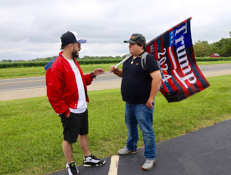Manny Collazo of Elgin (left) and Steve Roknic of Hobart, Ind. chat on Sunday, Aug. 18, 2024 in Lily Lake before participating in a caravan to a rally in Woodstock.