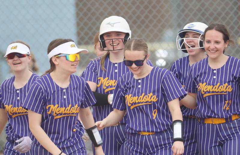 Mendota's Addison Perryman (center) smiles with her teammates after hitting her first of two home runs against Marquette on Wednesday, March 25, 2026 at June Gross Field in Ottawa.