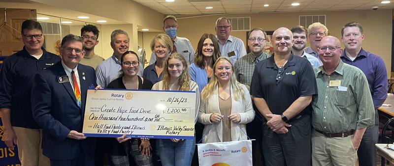 Members of the Illinois Valley Sunrise Rotary presented a symbolic check to Rotary District 6420 Governor Dave Emrick this week for being the first of 43 clubs in northern Illinois to complete the Create Hope Food Drive Challenge.