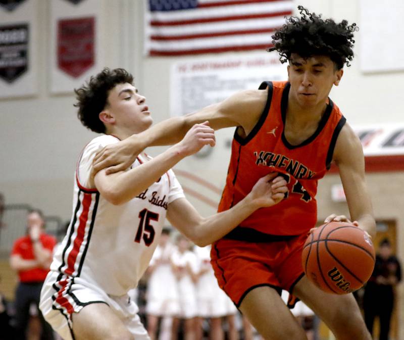 McHenry's Adam Anwar tries to drive to the basket against Huntley's Christian Wilson during a Fox Valley Conference boys basketball game Wednesday, Jan. 10, 2024, at Huntley High School.