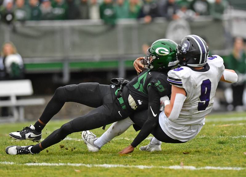 Downers Grove North’s William Vala (9) sacks Glenbard West quarterback AJ Rayford during a Class 7A second-round playoff game on November 8, 2025 at Glenbard West High School in Glen Ellyn.