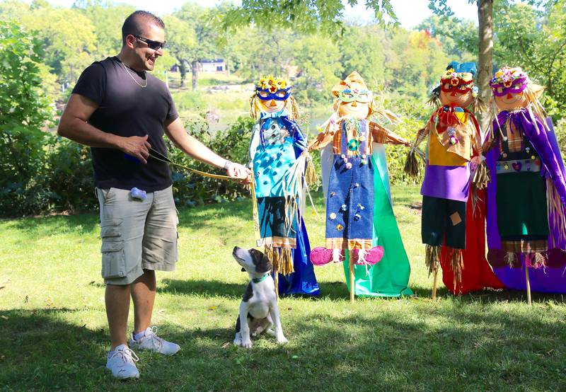 Luis Calvillo and adoptable puppy Shadow (from Rescued Rascals Dog
Rescue) wander around the Scarecrow Walk at Yorktoberfest in Yorkville on Saturday, Sep. 27, 2025.