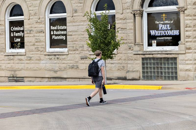 A pedestrian crosses Peoria Avenue at First Street on Thursday, Aug. 21, 2025, in Dixon. This and other intersections are scheduled for improvements.