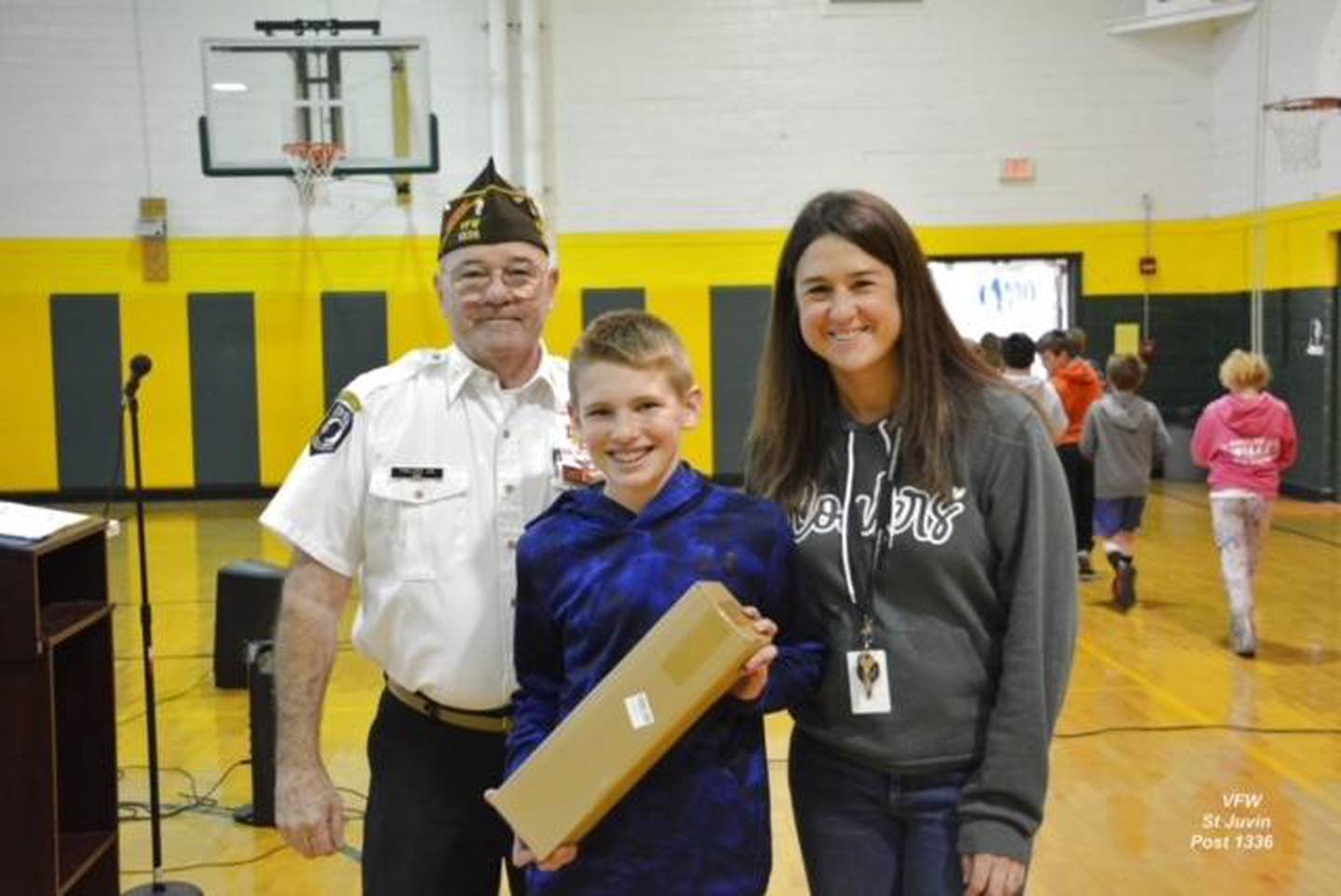 5th grade flag winner Caleb Hall with Commander Phillips and his teacher Amy Gaffigan