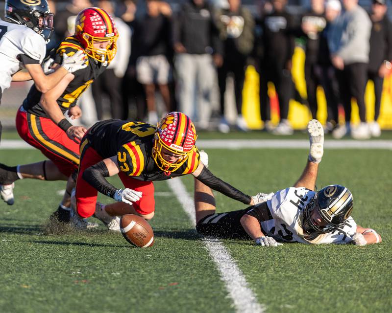 Batavia's Andrew Culotta goes for the lose ball against Glenbard North's Angelo Gatses at the Class 7A Quarter Final on Saturday, Nov.15,2025 in Batavia.